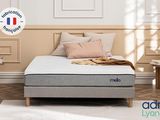 an image of a bed with a mattress and pillows in a room