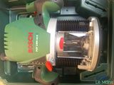 a green machine that is sitting inside of a box
