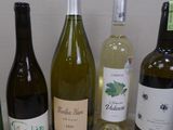 several bottles of wine are lined up on a table