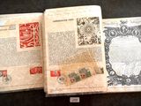 un livre ouvert avec des timbres, posé sur une table
