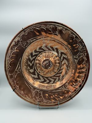 a close up of a plate on a stand on a table