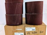 three brown sandpaper rolls are stacked on top of each other