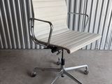 an image of a white office chair in front of a corrugated wall