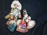 a lot of dolls that are sitting on a black surface