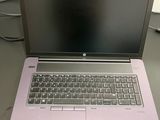 purple laptop computer sitting on top of a table next to a keyboard