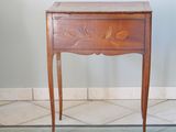 a small wooden table with a drawer on top of it