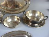 a silver plate with a silver bowl and a silver plate with a silver plate