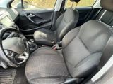 the interior of a small car with a steering wheel and a dashboard