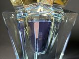 a glass vase with a purple liquid inside of it