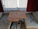 a small table with a bench in the middle of the room