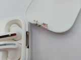 a white box with a pair of ear buds in it
