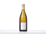 a bottle of white wine sitting on top of a table