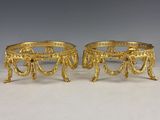 a pair of gold plated candlesticks
