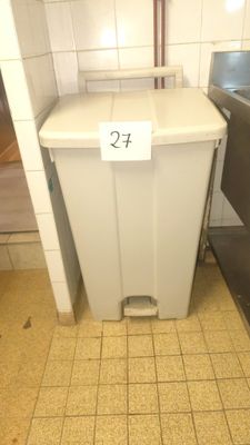 a trash can with a price tag on it in a public restroom