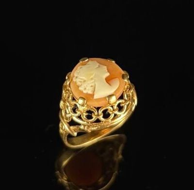 a close up of a gold ring with a cameo cameo on it