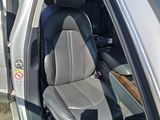 a silver car with a black seat in the back