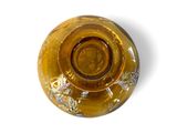 a yellow glass vase with a flower design on it