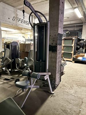 a gym room with equipment in the middle of the room