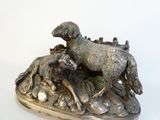 a statue of a sheep and a lamb on a rock