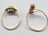 two gold rings with a skull on the top and a skull on the bottom
