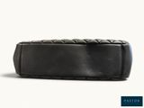 a close up of a black leather case on a white background