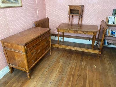 un parquet en bois massif dans une chambre avec du papier peint rose et des meubles en bois