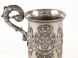 une coupe ancienne en argent avec une anse, sur fond blanc