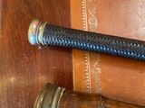 a leather bag with a leather handle and a leather sheath