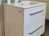 a white sink sitting on top of a wooden pallet
