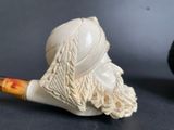 a picture of a pipe with a man ' s face on it