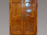an antique wooden armoire with two doors and two drawers