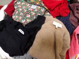 a pile of clothes that is sitting in a basket