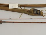 two fishing rods and a fishing bag on a table