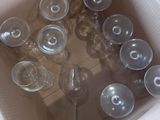 many empty wine glasses in a box on the floor