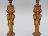 pair of antique brass candlesticks with carved figures on bases