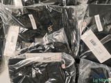 a pile of black shirts that are wrapped in plastic