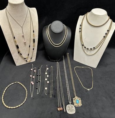 a group of necklaces and bracelets on display on a table