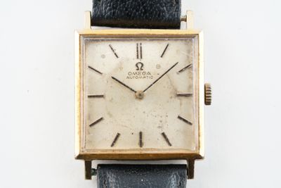 a watch that is sitting on a white surface