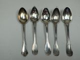 six spoons are lined up in a row on a table