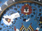 a plate with a picture of a bird and flowers on it