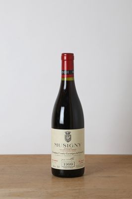 a bottle of red wine sitting on top of a wooden table