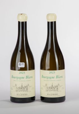 two bottles of wine sitting next to each other on a table