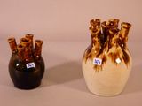 two vases sitting next to each other on a table