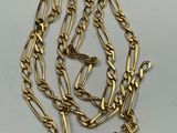 a close up of a gold chain with a clasp on it
