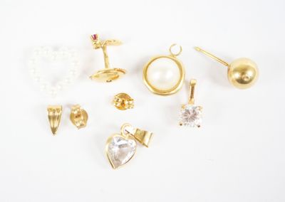 several pairs of earrings and rings on a white surface