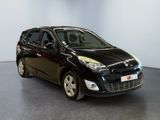 the small black car is parked in a large room