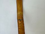 an image of a watch on a white surface with a brown strap