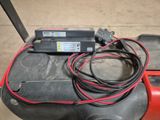 a red and black moped that has a charger on top of it