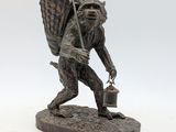 statue of a man carrying a basket and a bucket on his back