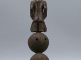 an image of a wooden figurine with a cat on top of it